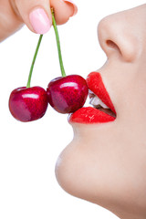 Close up of woman with red lips eating two berries, isolated - 56986266