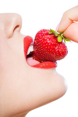 Obraz premium Close up of woman's mouth eating strawberry, isolated on white
