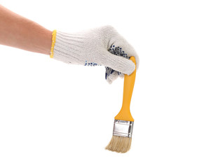 Hand in gloves holds brush.