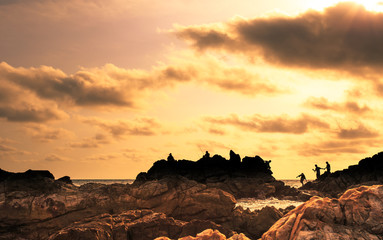 silhouette image of traveler at the sea and beautiful sunset,