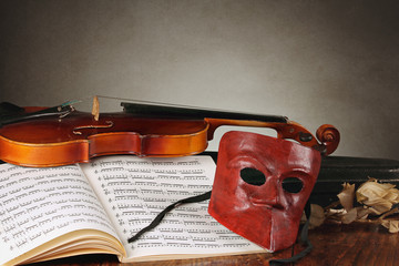 Venetian mask with old fiddle composition