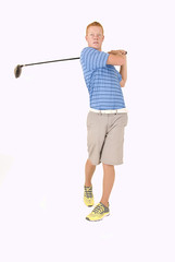 Tall redhead young man teeing off with driver and white backgrou