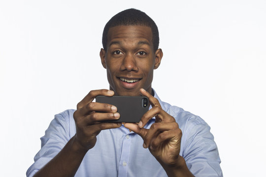 African American man taking picture with smartphone