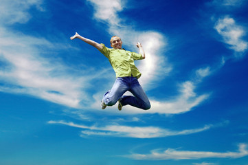 Obraz premium Jump of man under sky with clouds