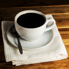 Cup of espresso on white napkin