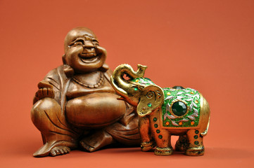 Laughing Buddha with a green ornate elephant