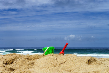 Colorful beach toys on sand