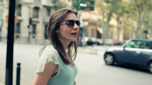 Attractive woman standing by the city street