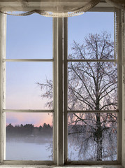 winter sunset viewed through old window