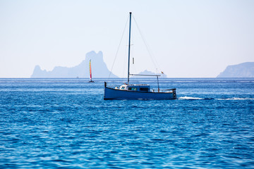 Es Vedra Ibiza silhouette with boats Formentera view