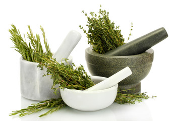 mortars with fresh green thyme and rosemary isolated on white