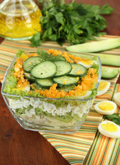 Delicious salad with eggs, cabbage and cucumbers on wooden