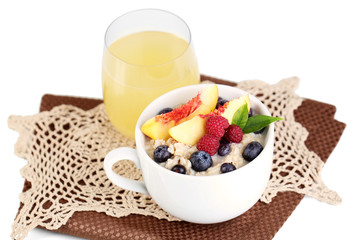 Oatmeal in cup with berries on napkins isolated on white