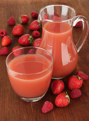 Delicious strawberry juice on table close-up