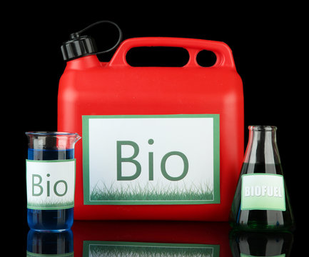 Bio fuels in canister and vials on black background
