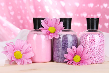Obraz na płótnie Canvas Aromatherapy minerals - colorful bath salt on pink background