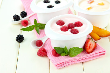 Delicious yogurt with fruit and berries on table close-up