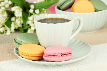 Coffee and macaroons on table close-up