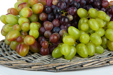 Naklejka na ściany i meble Fresh grape on wicker mat isolated on white