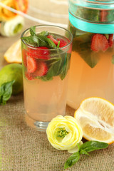 Basil lemonade with strawberry in  jug and glass,