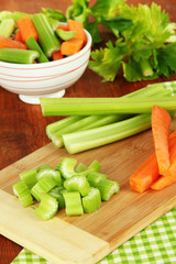 Fresh green celery with vegetables on table close-up