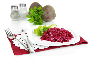 Beet salad on plate on napkins isolated on white