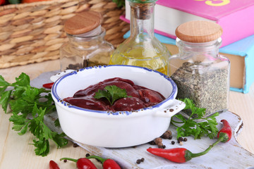 Raw liver in pan with spices and condiments