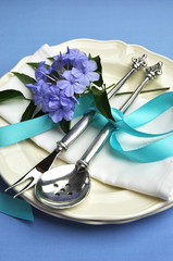 Fototapeta na wymiar Elegant blue theme table setting with flowers