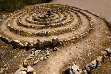 Atlantis spiral sign in Ibiza with stones on soil