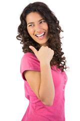 Dark haired young model posing thumb up