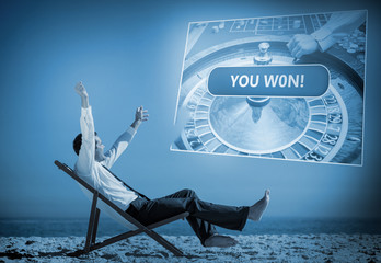 Businessman sitting on deck chair looking at holographic screen