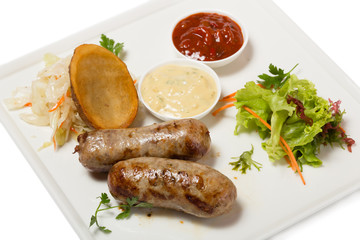 German sausages with roasted potatoes and sauerkraut.