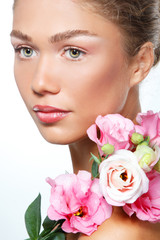 Beautiful young girl with with flowers, over white