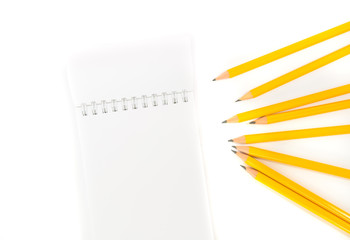 Notebook and pencils with isolated white background