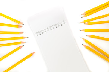 Notebook and pencils with isolated white background