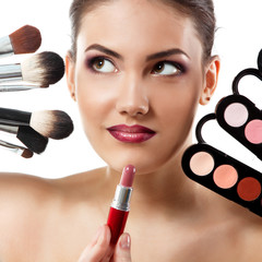 Fototapeta premium beauty portrait of young beautiful woman with makeup brushes, li