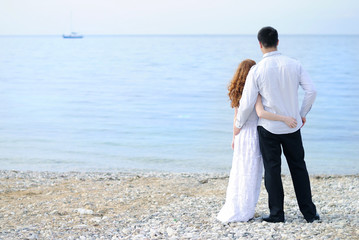 beautiful young couple in love near the sea