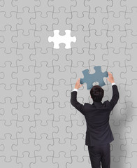 Businessman making a puzzle