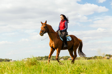 Young woman riding a horse