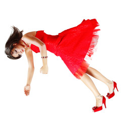 beatiful woman broken doll falling down in red dress isolated on