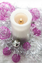 Obraz na płótnie Canvas White candle and Christmas decorations around