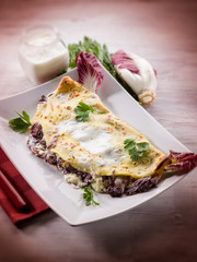 crepes with chicory and cheese, selective focus