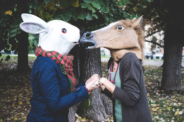 horse and rabbit mask women in the park - obrazy, fototapety, plakaty