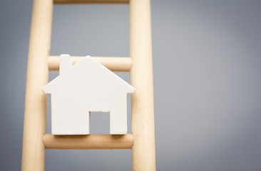 Model Houses On Rung Of Wooden Property Ladder © Daisy Daisy