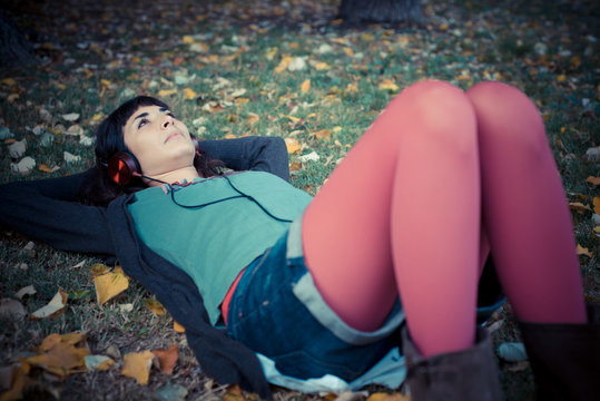 young beautiful woman listening to music autumn
