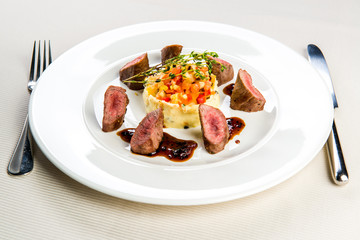 Beef and mashed potatoes decorated with vegetables