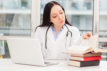 Female doctor is studying with books