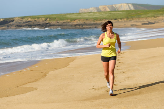 Woman running on sand beach