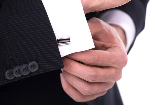 Close Up Of Businessman Wearing Cufflinks. Isolated On White