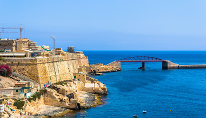 Breakwater bridge beside the old grand harbour of Valletta